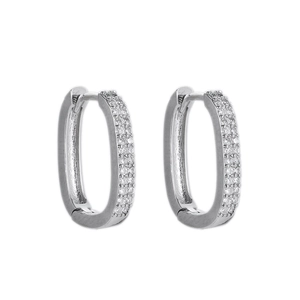 Detailed view of gold-plated geometric oval huggie earrings with micro-pave cubic zirconia