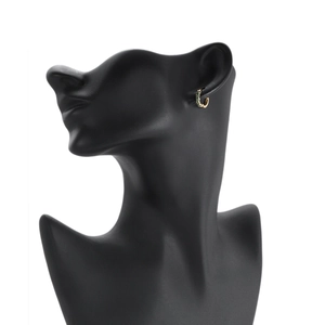 Minimalist gold hoop earrings with green round cut gemstones worn on model