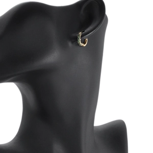 Gold plated hoop earrings with green emerald zircons displayed on a black ear model