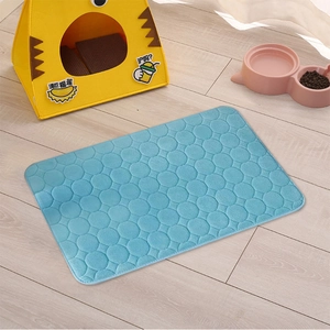 Close-up of sky blue cooling pet mat with ring quilting on a light wood floor