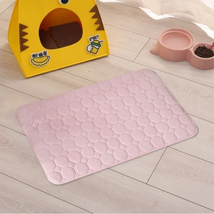Detail of pink coral fleece pet mat with circular quilting on light wood floor