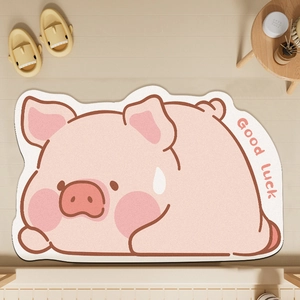 Close-up of pink pig shaped diatomaceous earth bath mat with Good luck text detail