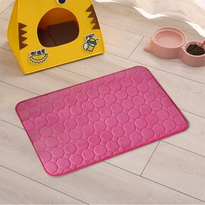 Pink coral fleece pet mat with quilted round patterns on light wood floor scene