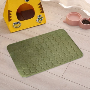 Close-up of green coral fleece pet mat featuring unique circular embossed texture