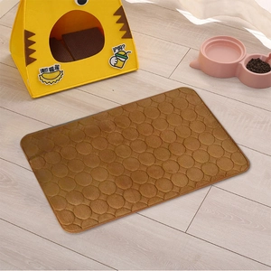 Brown coral fleece pet mat with quilted round texture on light wooden floor