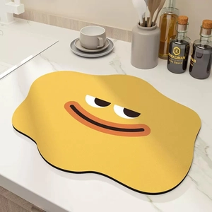 Detail of cartoon kitchen draining mat with smiley face on a marble countertop