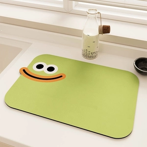 Detail of green kitchen drying mat featuring a minimalist cartoon smiley face design