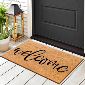 Brown fiber welcome doormat with black script text on indoor wooden floor entry