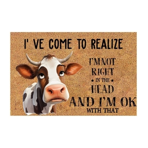 Rectangular brown coir door mat featuring a cute cartoon cow and funny quote text