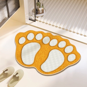 Detail of soft orange foot-shaped absorbent mat with white footprint pattern