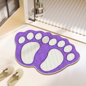 Close-up of thick purple cat paw bath mat with soft plush texture and white paw print