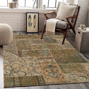 Detailed pattern of vintage patchwork carpet with floral motifs in a cozy living room