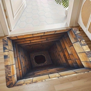 Macro detail of 3D visual illusion door mat featuring a deep wooden well perspective design
