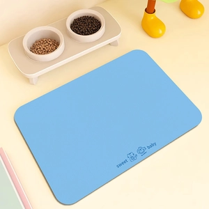 Detail of light blue pet feeding mat with cute cartoon cat and anti-slip texture