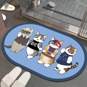 Detail view of oval absorbent bathroom mat with cute cartoon cats and blue border