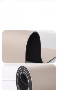 Detail of soft beige diatom mud mat showing flexible non-slip black rubber backing