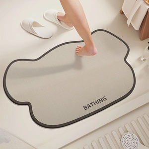 Absorbent diatomite bath mat with irregular shape and BATHING text in gray