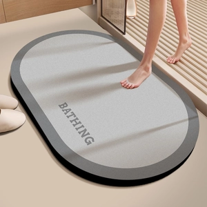 Oval diatom mud bath mat with gray bicolor stitching and BATHING text for anti-slip use