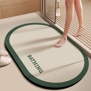 Oval diatom mud bathroom mat with BATHING text, non-slip absorbent green and beige rug