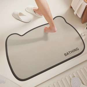 Macro detail of diatom mud bathroom mat with cat-shaped outline and Bathing text
