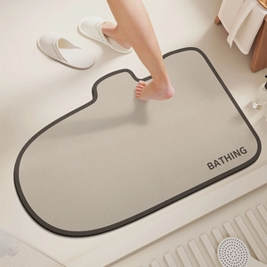 Irregular diatomaceous earth bath mat with bathing text and durable anti-slip surface