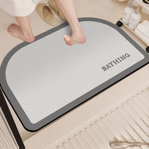 Close-up of semi-circle non-slip bath mat with BATHING text and soft texture detail