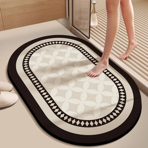 Detail of oval anti-slip bath mat with geometric patterns in a modern bathroom