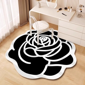 Close-up of black and white camellia shaped floral rug under a modern dressing table