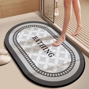 Close-up of oval anti-slip bath mat with Bathing text and geometric patterns
