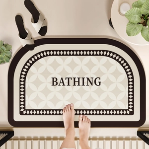 Vertical top view of beige diatom mud bath mat with BATHING text and geometric patterns