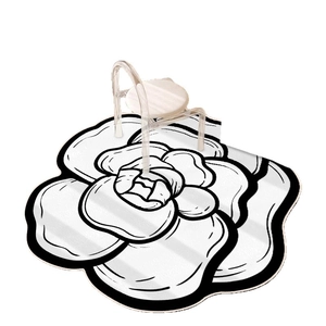 Irregular camellia flower floor mat with white base and black outline for home decor