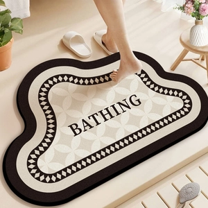 Detail of non-slip bath mat with BATHING text and geometric patterns in soft beige