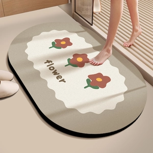 Macro view of a soft absorbent bathroom mat with red flower patterns and non-slip bottom