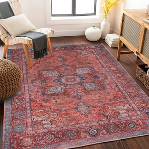 Detail of vintage Persian style rug with intricate geometric patterns in red and navy blue