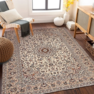Detail of bohemian persian rug with beige floral patterns on a wooden floor in living room