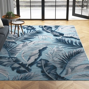 Detailed texture of imitation cashmere floral rug with blue tropical leaf patterns