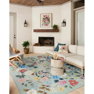 Detailed texture of a non-slip floral faux cashmere rug in a sunroom setting