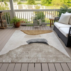 Detail of a modern geometric outdoor rug with abstract pebble shapes on a wooden deck