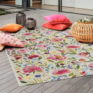 Detail of floral patterned faux cashmere rug with high-density woven texture on wood floor