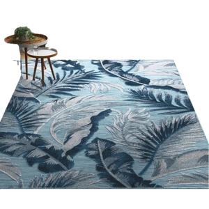 Faux cashmere area rug with tropical leaf patterns in blue and grey for living room