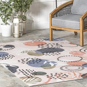Macro detail of geometric modern area rug featuring soft pink and blue abstract patterns