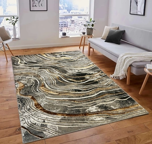 Detailed view of abstract marble pattern area rug with gold and grey fluid textures