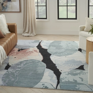 Detail of modern abstract rug with low-saturation blue and pink ink wash patterns