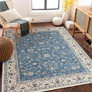 Close-up of bohemian navy blue and beige rug with intricate oriental floral motifs