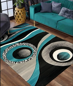 Detail of teal blue and grey abstract rug showing soft plush texture in a modern living room
