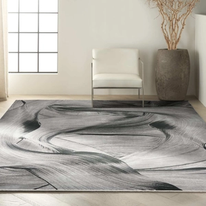 Detailed close-up of modern abstract rug showing black and white flowing ink patterns