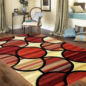 Modern abstract geometric area rug with red and black circular patterns on wood floor
