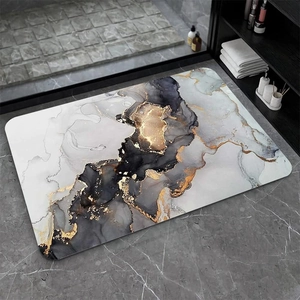 Modern marble pattern diatom mud bath mat with gold accents on grey textured floor