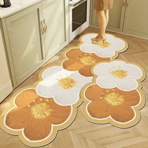 Detailed view of floral daisy kitchen mats with non-slip texture on light wood floor