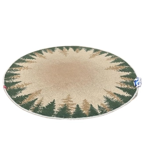 Round Christmas rug with green pine tree pattern on beige plush background, top view
